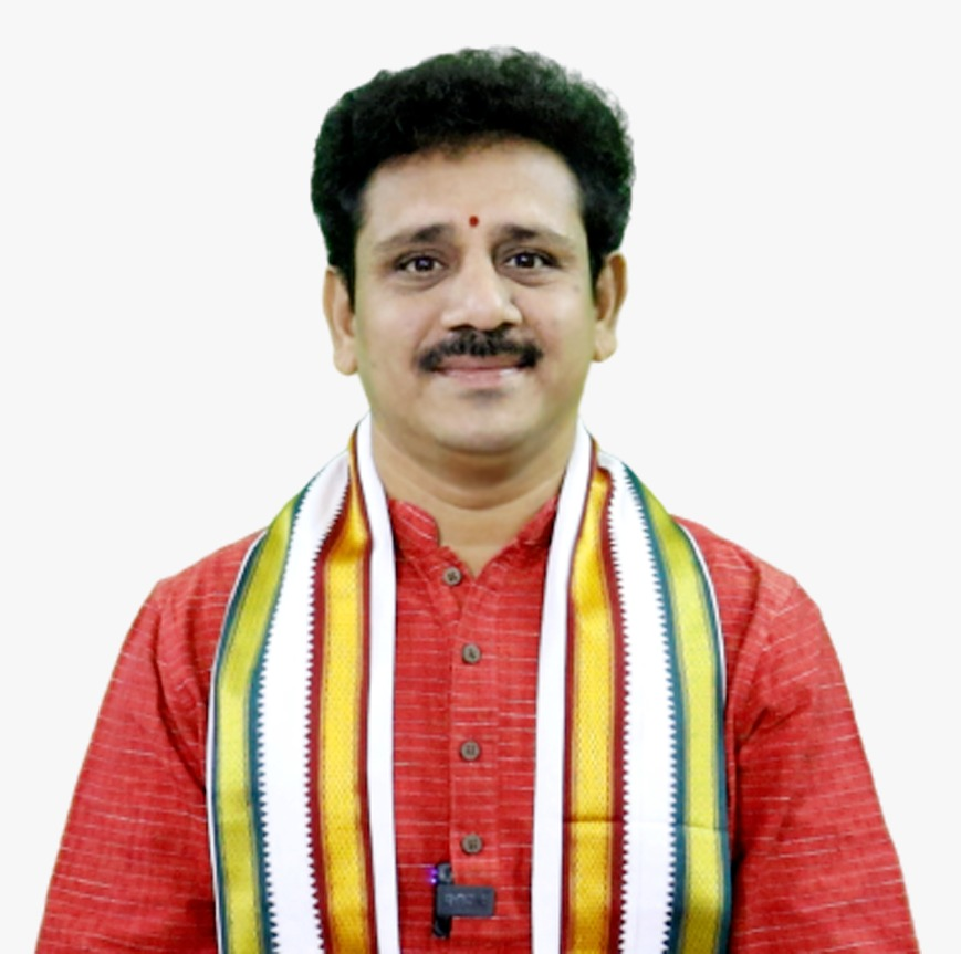 Dr. V. V. Mohan Kumar at desk
